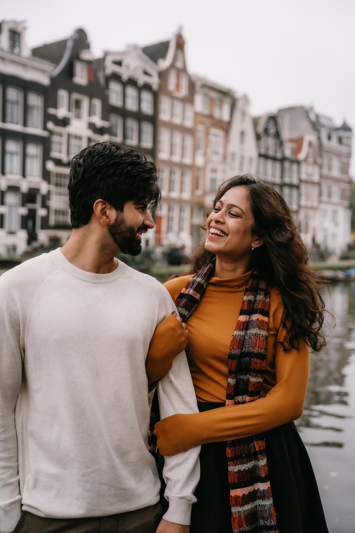 Pulkit Mendiratta and Shivli Gupta, the founders of Alfaaz, by the canal houses in Amsterdam.